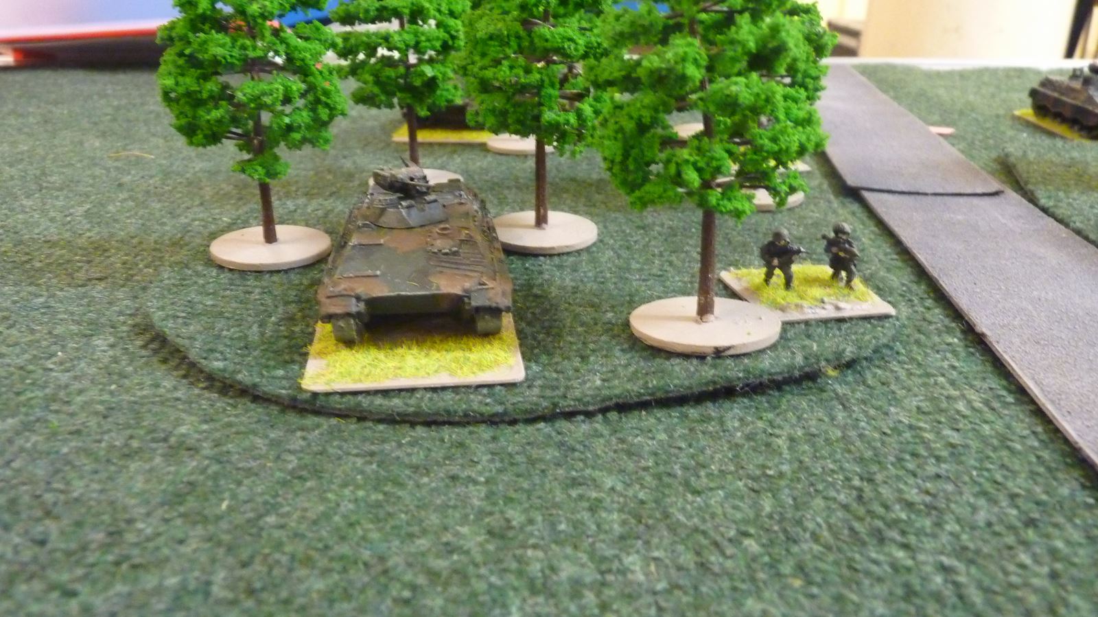 A Marder fires from its hiding place in the wood=